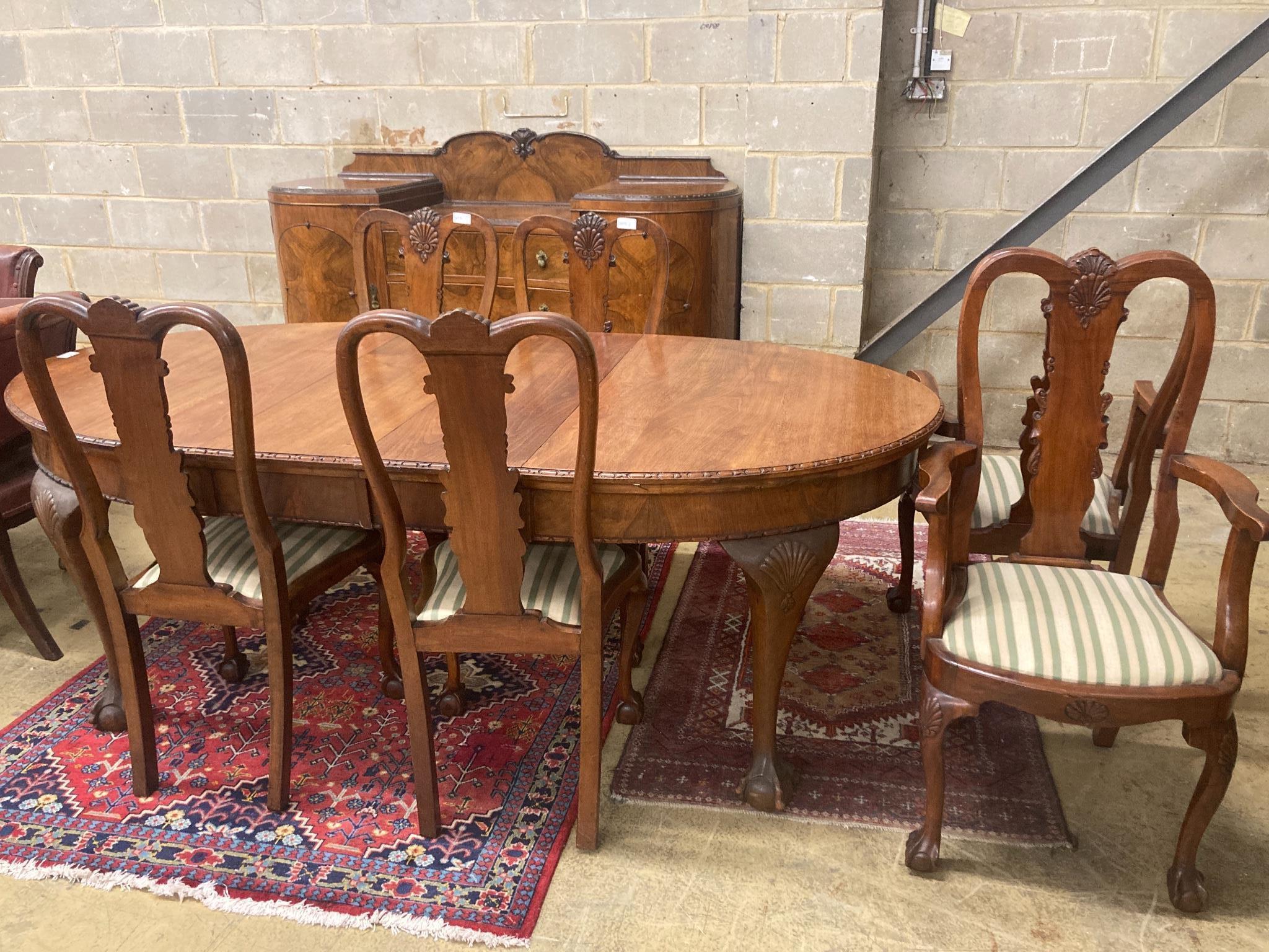 A Queen Anne style figured walnut dining suite comprising extending dining table, 200cm extended (one spare leaf), width 104cm, height 76cm, six chairs (two with arms) and a concave fronted sideboard